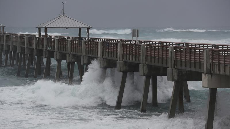 Waves crash along the Juno Beach Pier as Tropical Storm Isaias passes through the area Sunday in Juno Beach, Fla. The storm is now headed toward the Carolinas. Waves crash along the Juno Beach Pier as Tropical Storm Isaias passes through the area Sunday in Juno Beach, Fla. The storm is now headed toward the Carolinas.