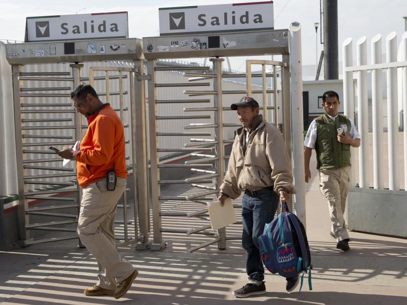 Carlos Catarldo Gomez, of Honduras, center, is escorted by Mexican officials after leaving the United States, the first person returned to Mexico to wait for his asylum trial date, in Tijuana, Mexico Carlos Catarldo Gomez, of Honduras, center, is escorted by Mexican officials after leaving the United States, the first person returned to Mexico to wait for his asylum trial date, in Tijuana, Mexico