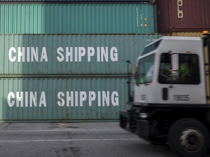 A truck passes a stack of China Shipping containers at the Port of Savannah in Georgia on July 5, 2018. The Trump administration is delaying some tariffs from taking effect until December. A truck passes a stack of China Shipping containers at the Port of Savannah in Georgia on July 5, 2018. The Trump administration is delaying some tariffs from taking effect until December.