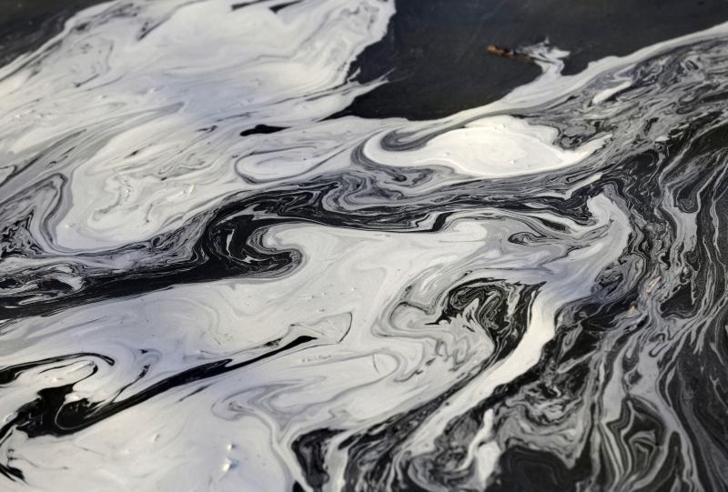 Coal ash swirls on the surface of the Dan River following one of the worst coal-ash spills in U.S. history into the river in Danville, Va., in February 2014. The Environmental Protection Agency wants to ease restrictions on coal ash and wastewater from co Coal ash swirls on the surface of the Dan River following one of the worst coal-ash spills in U.S. history into the river in Danville, Va., in February 2014. The Environmental Protection Agency wants to ease restrictions on coal ash and wastewater from co