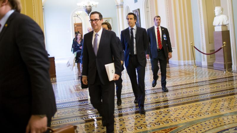 Treasury Secretary Steve Mnuchin (center) arrives Tuesday at a meeting with congressional leaders to discuss a tax overhaul. Treasury Secretary Steve Mnuchin (center) arrives Tuesday at a meeting with congressional leaders to discuss a tax overhaul.