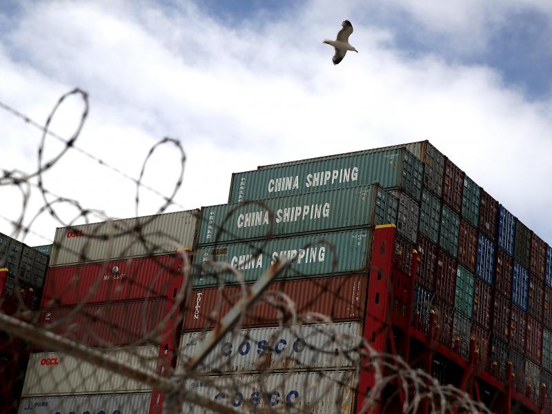 Shipping containers sit on a Hong Kong-based container ship at the Port of Oakland in California last month. The cost of the tariffs is likely to ripple through the global supply chains that make up much of the trade between the U.S. and China. Shipping containers sit on a Hong Kong-based container ship at the Port of Oakland in California last month. The cost of the tariffs is likely to ripple through the global supply chains that make up much of the trade between the U.S. and China.