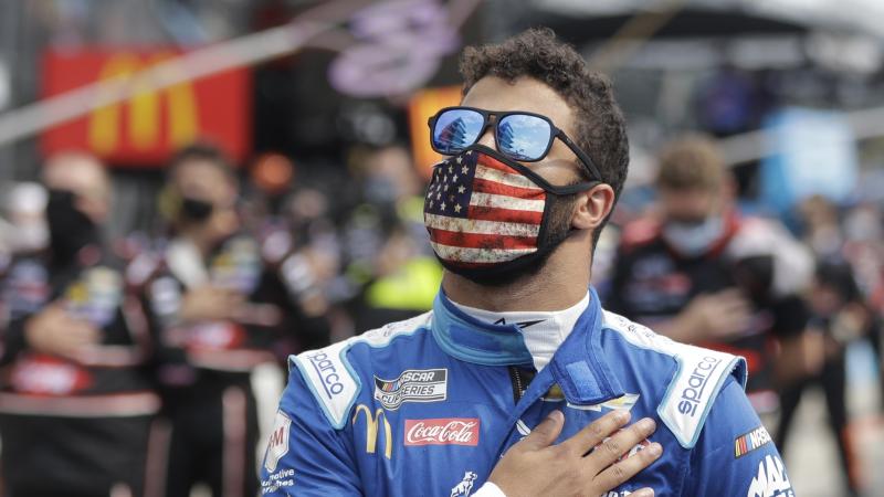 NASCAR Cup Series driver Bubba Wallace stands during the national anthem before a NASCAR auto race Sunday at the Indianapolis Motor Speedway in Indianapolis. NASCAR Cup Series driver Bubba Wallace stands during the national anthem before a NASCAR auto race Sunday at the Indianapolis Motor Speedway in Indianapolis.