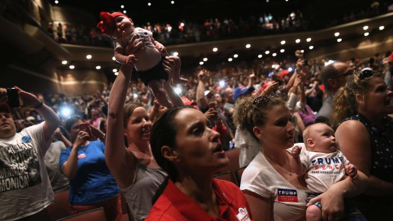 Women hold up their babies for Republican presidential nominee Donald Trump as he speaks at a campaign rally on Aug. 1 in Mechanicsburg, Pa. Women hold up their babies for Republican presidential nominee Donald Trump as he speaks at a campaign rally on Aug. 1 in Mechanicsburg, Pa.