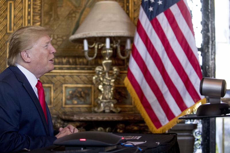 President Donald Trump speaks during a Christmas Eve video teleconference with members of the military at his Mar-a-Lago estate in Palm Beach, Fla. President Donald Trump speaks during a Christmas Eve video teleconference with members of the military at his Mar-a-Lago estate in Palm Beach, Fla.