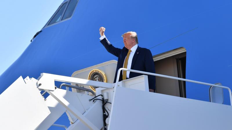 President Trump waves before boarding Air Force One as he departs Albuquerque, N.M., en route to campaign events in California on Tuesday. President Trump waves before boarding Air Force One as he departs Albuquerque, N.M., en route to campaign events in California on Tuesday.