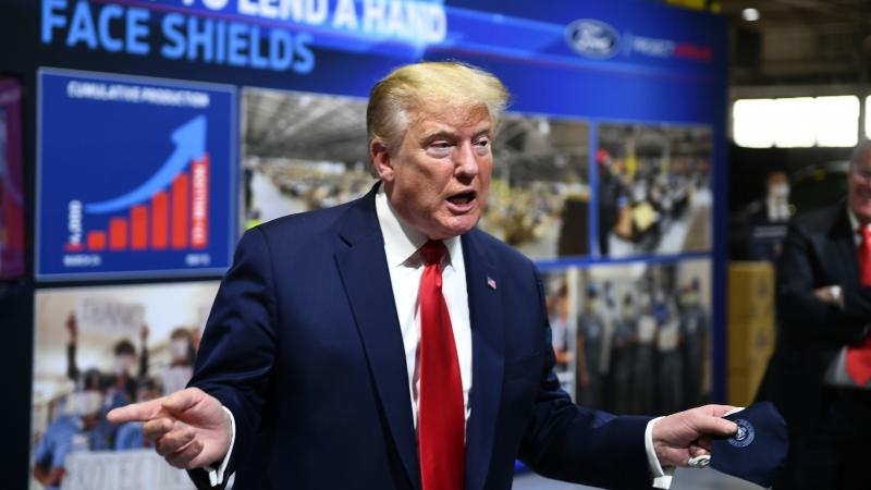 President Trump holds a mask as he speaks during a tour of the Ford Rawsonville Plant in Ypsilanti, Mich., on Thursday. President Trump holds a mask as he speaks during a tour of the Ford Rawsonville Plant in Ypsilanti, Mich., on Thursday.
