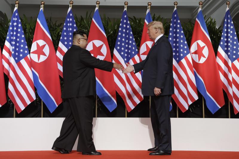 North Korean leader Kim Jong Un reaches to shake President Trump's hand at the Capella resort on Sentosa Island in Singapore on Tuesday. North Korean leader Kim Jong Un reaches to shake President Trump's hand at the Capella resort on Sentosa Island in Singapore on Tuesday.