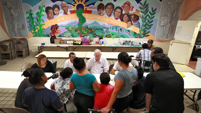 Ruben Garcia (center), director of the Annunciation House, speaks with migrant parents on June 26, 2018, in El Paso, Texas. Ruben Garcia (center), director of the Annunciation House, speaks with migrant parents on June 26, 2018, in El Paso, Texas.