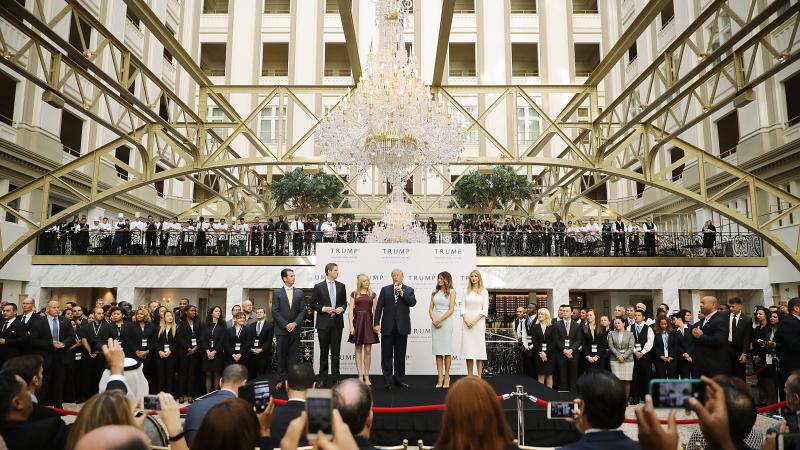 Donald Trump (center) and his family (from left), son Donald Trump Jr., son Eric Trump, wife Melania Trump and daughters Tiffany Trump and Ivanka Trump, prepare to cut the ribbon Wednesday at the Trump International Hotel Washington, D.C. Donald Trump (center) and his family (from left), son Donald Trump Jr., son Eric Trump, wife Melania Trump and daughters Tiffany Trump and Ivanka Trump, prepare to cut the ribbon Wednesday at the Trump International Hotel Washington, D.C.