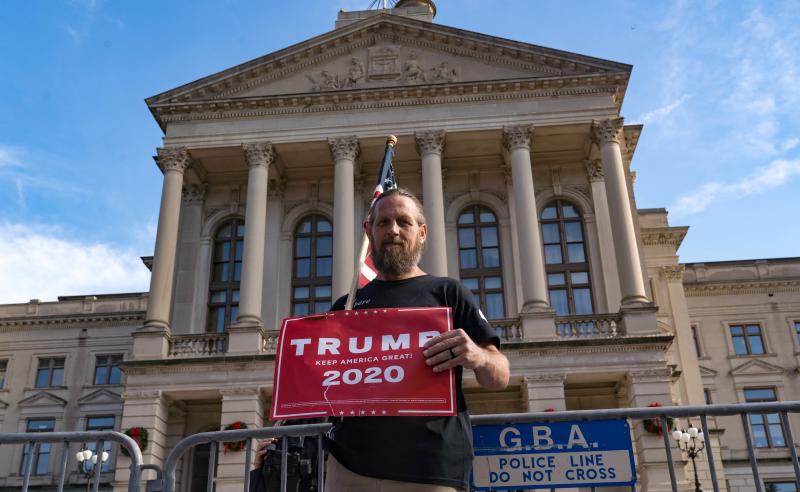 A supporter of President Trump protests outside the Georgia State Capitol on Saturday in Atlanta. The president's campaign has requested a vote recount in the state. A supporter of President Trump protests outside the Georgia State Capitol on Saturday in Atlanta. The president's campaign has requested a vote recount in the state.