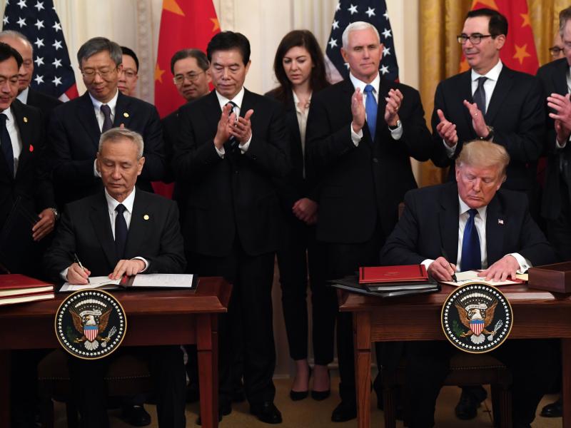 President Trump and Vice Premier Liu He, China's top trade negotiator, sign a "Phase 1" trade agreement between the U.S. and China at the White House on Wednesday. President Trump and Vice Premier Liu He, China's top trade negotiator, sign a "Phase 1" trade agreement between the U.S. and China at the White House on Wednesday.