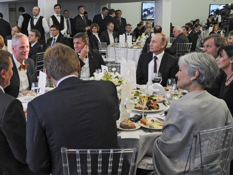 Russian President Vladimir Putin sits next to Flynn at an exhibition marking the 10th anniversary of RT (Russia Today) in Moscow on Dec. 10, 2015. Russian President Vladimir Putin sits next to Flynn at an exhibition marking the 10th anniversary of RT (Russia Today) in Moscow on Dec. 10, 2015.