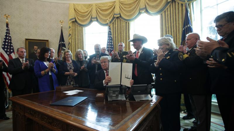President Trump shows the executive veto of the national emergency resolution in the Oval Office of the White House Friday. President Trump shows the executive veto of the national emergency resolution in the Oval Office of the White House Friday.