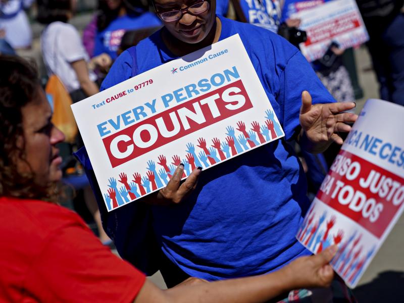 A demonstrator hands out a sign about the 2020 census outside the U.S. Supreme Court in Washington, D.C., in 2019. The Census Bureau is projecting the first set of census numbers won't be ready until February, Trump administration attorneys told a federal A demonstrator hands out a sign about the 2020 census outside the U.S. Supreme Court in Washington, D.C., in 2019. The Census Bureau is projecting the first set of census numbers won't be ready until February, Trump administration attorneys told a federal