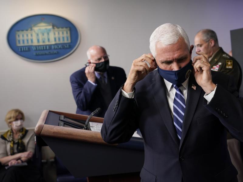 Vice President Pence adjusts his face mask during a news conference with the coronavirus task force at the White House on Thursday. Vice President Pence adjusts his face mask during a news conference with the coronavirus task force at the White House on Thursday.