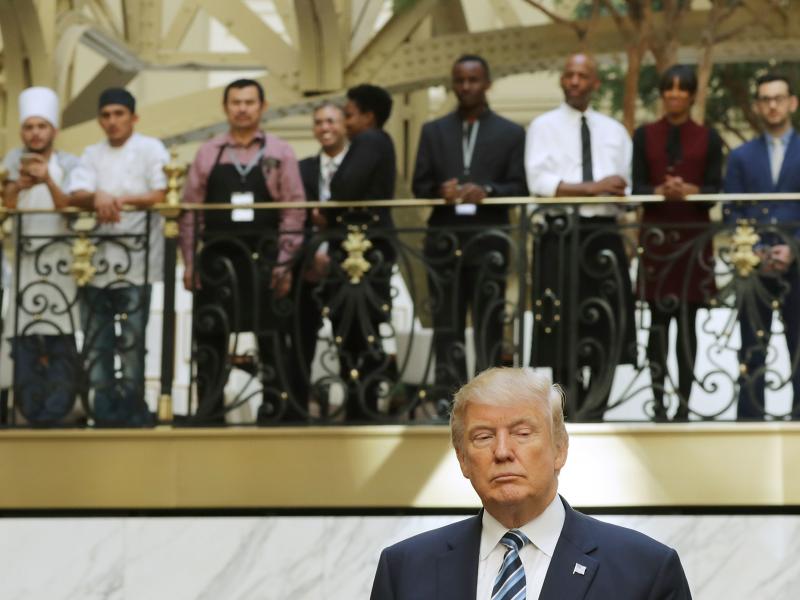 Hotel employees watch Donald Trump following a ribbon-cutting ceremony at the new Trump International Hotel on Oct. 26 in Washington, D.C. Hotel employees watch Donald Trump following a ribbon-cutting ceremony at the new Trump International Hotel on Oct. 26 in Washington, D.C.
