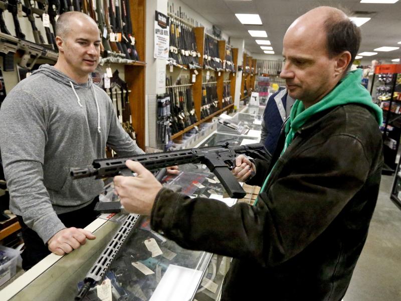 Wes Morosky, owner of Duke's Sport Shop. left, helps Ron Detka as he shops for a rifle at his store in New Castle, Penn. Wes Morosky, owner of Duke's Sport Shop. left, helps Ron Detka as he shops for a rifle at his store in New Castle, Penn.
