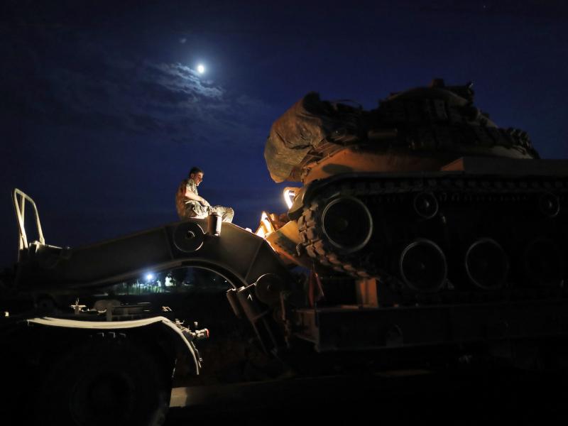 A Turkish army officer prepares to unload a tank from a truck to its new position on the Turkish side of the border between Turkey and Syria, in Sanliurfa province, southeastern Turkey, on Tuesday. A Turkish army officer prepares to unload a tank from a truck to its new position on the Turkish side of the border between Turkey and Syria, in Sanliurfa province, southeastern Turkey, on Tuesday.