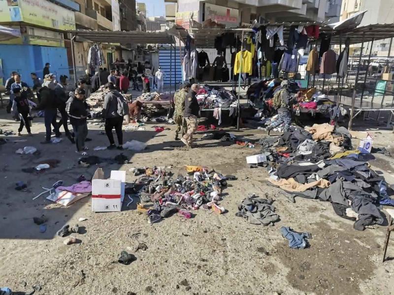 People and security forces gather at the site of deadly bomb attacks Thursday in a Baghdad market. The rare suicide bombings killed and wounded dozens of civilians. People and security forces gather at the site of deadly bomb attacks Thursday in a Baghdad market. The rare suicide bombings killed and wounded dozens of civilians.
