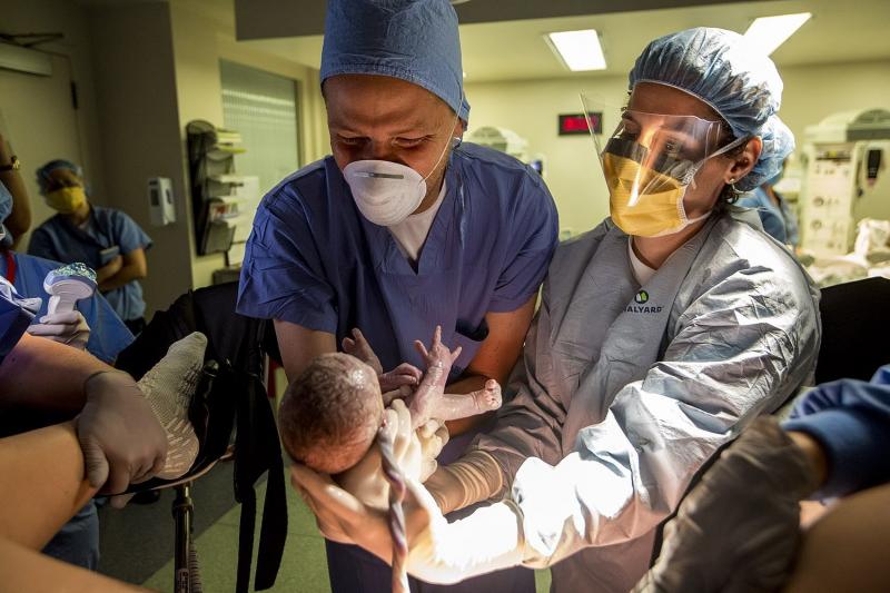 Dr. Ruth Levesque (right) hands Shaun McDougall his newborn son Brady at South Shore Hospital in Weymouth, Mass. The birth of the second twin, Bryce, was much trickier than Brady's. Good communication between the health team and parents was crucial to saf Dr. Ruth Levesque (right) hands Shaun McDougall his newborn son Brady at South Shore Hospital in Weymouth, Mass. The birth of the second twin, Bryce, was much trickier than Brady's. Good communication between the health team and parents was crucial to saf
