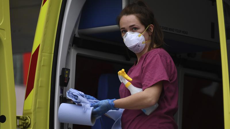 A medical worker cleans an ambulance at St. Thomas' Hospital, one of the many hospitals dealing with coronavirus patients in London. U.K. health care personnel say they are not receiving enough tests for the virus themselves. A medical worker cleans an ambulance at St. Thomas' Hospital, one of the many hospitals dealing with coronavirus patients in London. U.K. health care personnel say they are not receiving enough tests for the virus themselves.