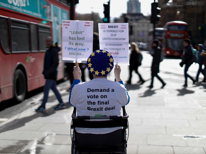 An anti-Brexit activist demonstrates outside of the Houses of Parliament in London on Thursday, before a vote on whether to postpone Britain's exit from the European Union. An anti-Brexit activist demonstrates outside of the Houses of Parliament in London on Thursday, before a vote on whether to postpone Britain's exit from the European Union.