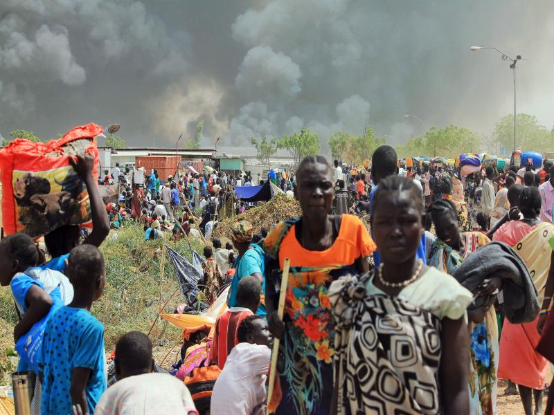 South Sudanese civilians flee fighting in the northeastern town of Malakal on February 18, 2016, where gunmen opened fire on civilians sheltering inside a United Nations base. South Sudanese civilians flee fighting in the northeastern town of Malakal on February 18, 2016, where gunmen opened fire on civilians sheltering inside a United Nations base.