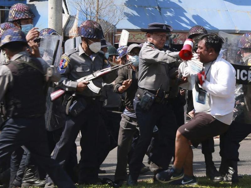 Police arrest a protester during a demonstration against the military coup in Mawlamyine, in Myanmar's Mon State, on Friday. Police arrest a protester during a demonstration against the military coup in Mawlamyine, in Myanmar's Mon State, on Friday.