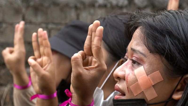 Protesters, wearing red makeup to simulate tears of blood, making the three-finger salute during a demonstration against the military coup in Hlaing Township, Yangon, Myanmar, on Thursday in a photo taken from a screenshot from AFPTV video. Protesters, wearing red makeup to simulate tears of blood, making the three-finger salute during a demonstration against the military coup in Hlaing Township, Yangon, Myanmar, on Thursday in a photo taken from a screenshot from AFPTV video.