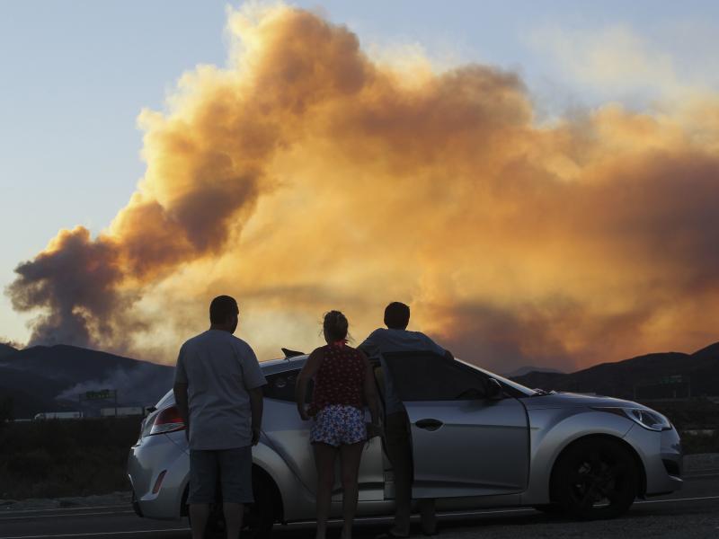 People watch the Blue Cut Fire in Lytle Creek, Calif., in 2016. People watch the Blue Cut Fire in Lytle Creek, Calif., in 2016.