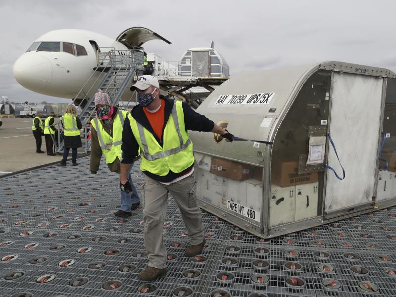 Two shipping containers holding the first doses of the Pfizer and BioNTech COVID-19 vaccine arrived at the UPS Worldport in Louisville, Ky., on Sunday. Two shipping containers holding the first doses of the Pfizer and BioNTech COVID-19 vaccine arrived at the UPS Worldport in Louisville, Ky., on Sunday.