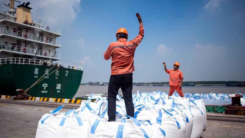 Dock workers unload bags of chemicals earlier this month at a port in Zhangjiagang, north of Shanghai. Dock workers unload bags of chemicals earlier this month at a port in Zhangjiagang, north of Shanghai.