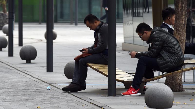 An international tariff on high-tech goods could be rewritten, thanks to negotiations in China. Here, men use smartphones in Beijing last month, days after Apple released its iPhone 6 in the Chinese market. An international tariff on high-tech goods could be rewritten, thanks to negotiations in China. Here, men use smartphones in Beijing last month, days after Apple released its iPhone 6 in the Chinese market.