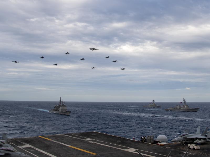 Aircraft assigned to Carrier Air Wing (CVW) 17 fly over the Theodore Roosevelt Carrier Strike Group and the Nimitz Carrier Strike Group in the South China Sea on Tuesday. Aircraft assigned to Carrier Air Wing (CVW) 17 fly over the Theodore Roosevelt Carrier Strike Group and the Nimitz Carrier Strike Group in the South China Sea on Tuesday.