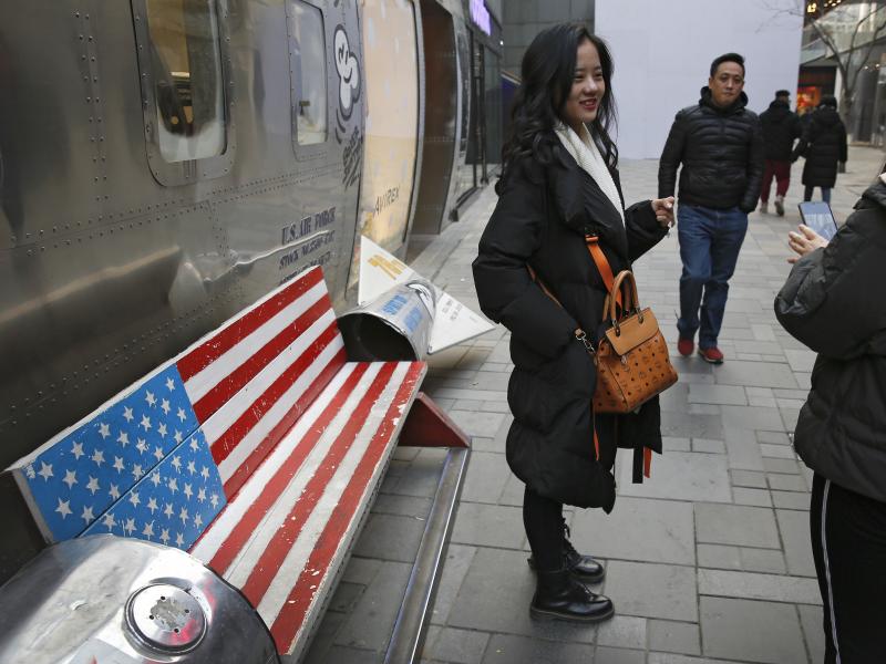 Chinese shoppers spend their time next to a bench painted with the U.S. flag at the capital city's popular shopping mall in Beijing. During trade talks this week, the two sides face potentially lengthy wrangling over technology and the future of their eco Chinese shoppers spend their time next to a bench painted with the U.S. flag at the capital city's popular shopping mall in Beijing. During trade talks this week, the two sides face potentially lengthy wrangling over technology and the future of their eco