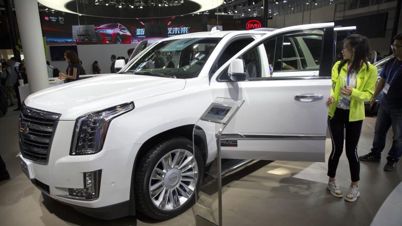 Visitors look at a Cadillac Escalade at the China Auto Show in Beijing in 2018. For General Motors, China is a bigger market than the United States. Visitors look at a Cadillac Escalade at the China Auto Show in Beijing in 2018. For General Motors, China is a bigger market than the United States.