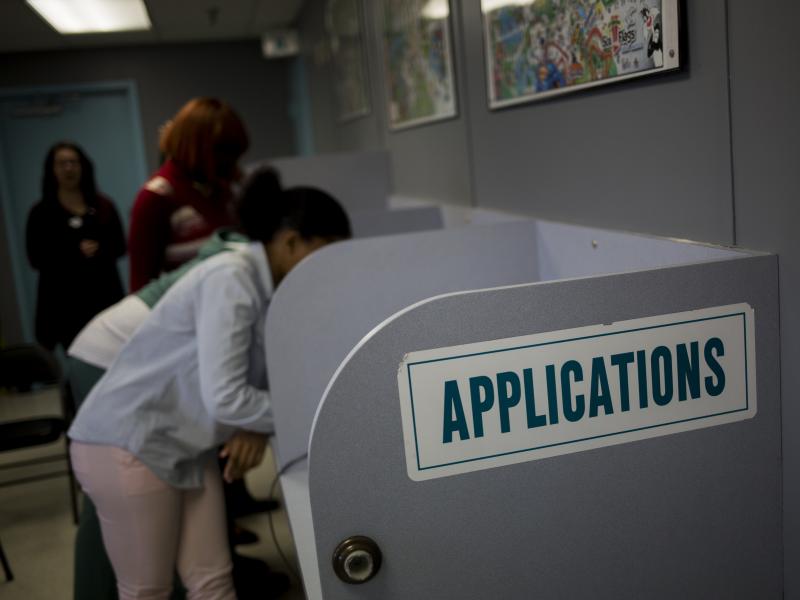 Job seekers fill out applications inside the employment center at the Six Flags Entertainment Corp. Great Adventure amusement park in Jackson, N.J., in March. Job seekers fill out applications inside the employment center at the Six Flags Entertainment Corp. Great Adventure amusement park in Jackson, N.J., in March.