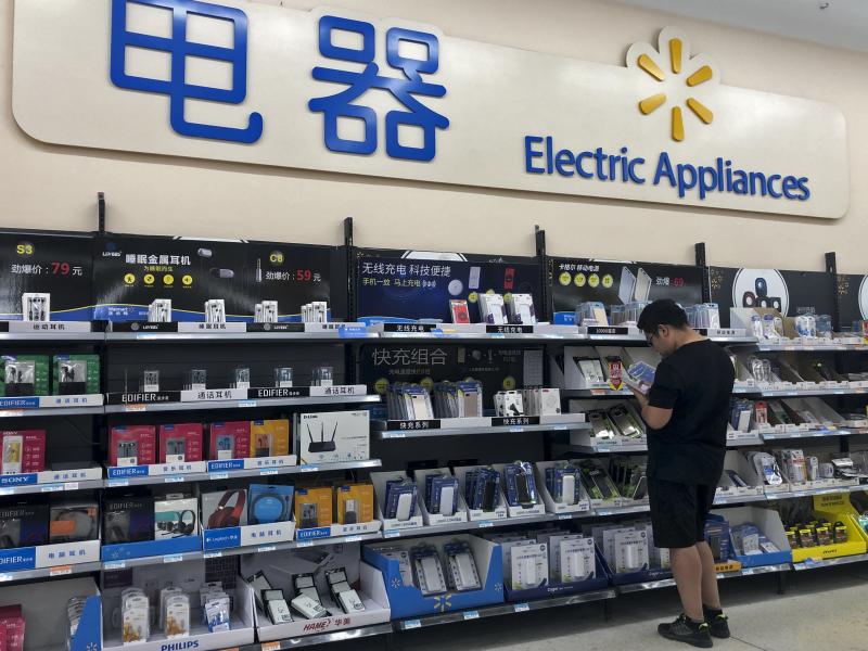 A shopper browses digital products at a market in Beijing. Trade tensions between China and the United States have grown significantly this week, after the Trump administration accused Beijing of backing down from commitments it had made in trade negotiat A shopper browses digital products at a market in Beijing. Trade tensions between China and the United States have grown significantly this week, after the Trump administration accused Beijing of backing down from commitments it had made in trade negotiat