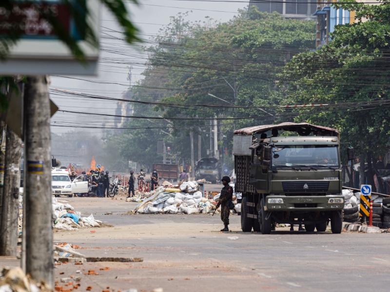 Security forces stand guard on a road as people are arrested, next to dismantled barricades that were set up by protesters demonstrating against the military coup, in Yangon, Myanmar, on Friday. Security forces stand guard on a road as people are arrested, next to dismantled barricades that were set up by protesters demonstrating against the military coup, in Yangon, Myanmar, on Friday.