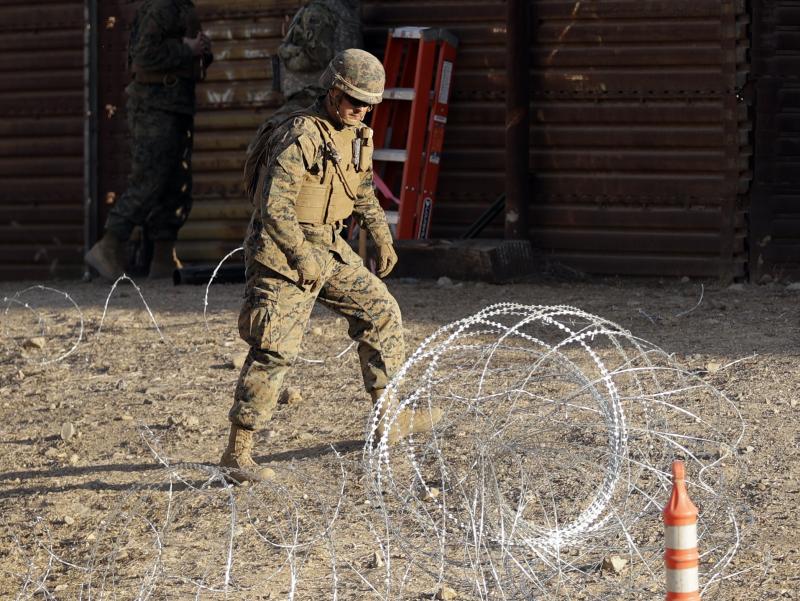A Marine uses concertina wire to fortify the border separating Tijuana, Mexico, and San Diego, near the San Ysidro Port of Entry. A Marine uses concertina wire to fortify the border separating Tijuana, Mexico, and San Diego, near the San Ysidro Port of Entry.
