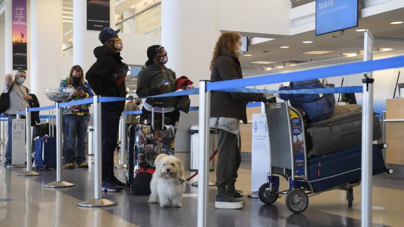 Travelers wait to check baggage for an American Airlines flight at Los Angeles International Airport on Wednesday. The Centers for Disease Control and Prevention is urging people to not travel for Thanksgiving. Travelers wait to check baggage for an American Airlines flight at Los Angeles International Airport on Wednesday. The Centers for Disease Control and Prevention is urging people to not travel for Thanksgiving.