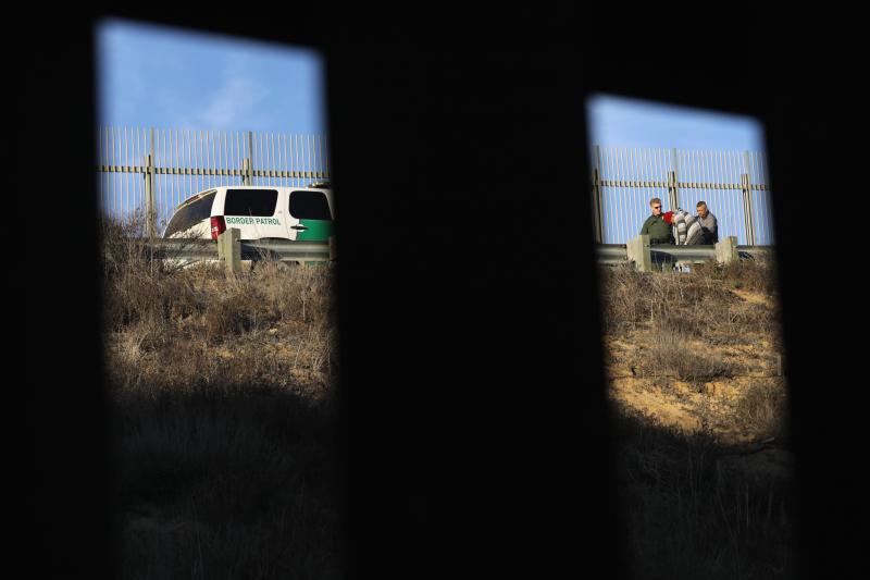 A U.S. Border Patrol agent takes an immigrant into custody in December 2018. Numerous members of the migrant caravan crossed over from Tijuana to San Diego but were quickly taken into custody by U.S. Border Patrol agents. A U.S. Border Patrol agent takes an immigrant into custody in December 2018. Numerous members of the migrant caravan crossed over from Tijuana to San Diego but were quickly taken into custody by U.S. Border Patrol agents.
