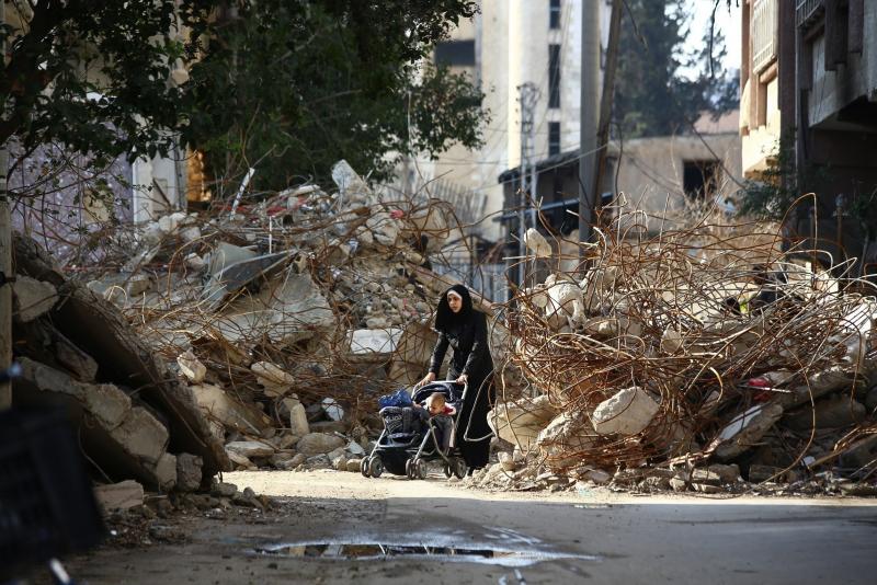 A woman navigates a stroller between the rubble of destroyed buildings in the rebel bastion of Douma, Syria, in December 2014. A new report card on the international response to Syria's violence faults the U.N. Security Council. A woman navigates a stroller between the rubble of destroyed buildings in the rebel bastion of Douma, Syria, in December 2014. A new report card on the international response to Syria's violence faults the U.N. Security Council.