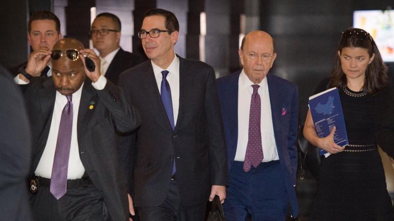 Treasury Secretary Steven Mnuchin (center left) and Commerce Secretary Wilbur Ross (center right) walk through a hotel lobby as they head to a state guest house to meet Chinese officials in Beijing on Friday. The talks included a "thorough exchange of vie Treasury Secretary Steven Mnuchin (center left) and Commerce Secretary Wilbur Ross (center right) walk through a hotel lobby as they head to a state guest house to meet Chinese officials in Beijing on Friday. The talks included a "thorough exchange of vie