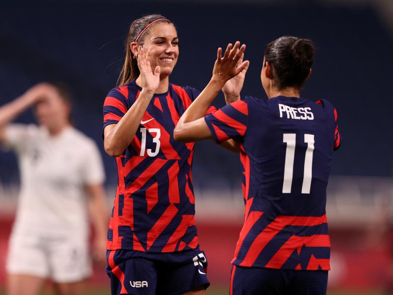 Alex Morgan (#13) celebrates another Team USA goal against New Zealand with teammate Christen Press (#11) at the Tokyo Olympics on Saturday in Saitama, Japan. Alex Morgan (#13) celebrates another Team USA goal against New Zealand with teammate Christen Press (#11) at the Tokyo Olympics on Saturday in Saitama, Japan.