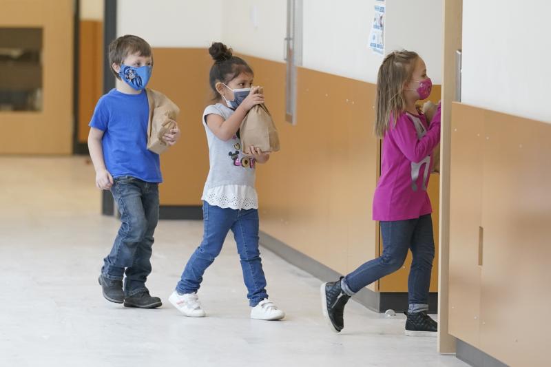 Students carry sack lunches at Elk Ridge Elementary School in Buckley, Wash. On Monday, USDA unveiled a new program that would feed millions of children over the summer, when many schools are closed. Students carry sack lunches at Elk Ridge Elementary School in Buckley, Wash. On Monday, USDA unveiled a new program that would feed millions of children over the summer, when many schools are closed.