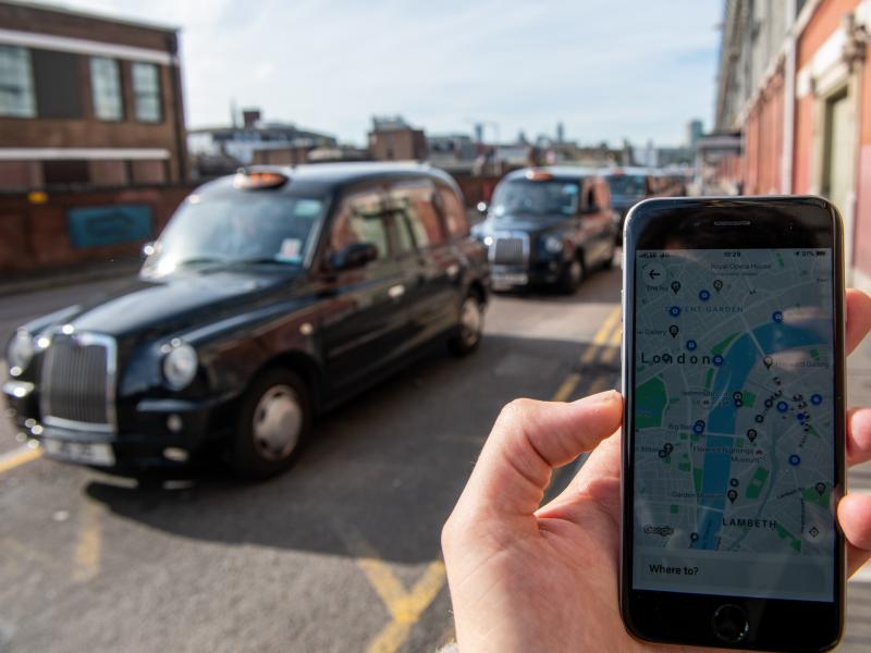 A phone shows the Uber app in front of a taxi stand at Waterloo station in London on Monday. The ride-sharing service won its appeal after Transport for London denied a renewal of its operating license late last year. A phone shows the Uber app in front of a taxi stand at Waterloo station in London on Monday. The ride-sharing service won its appeal after Transport for London denied a renewal of its operating license late last year.