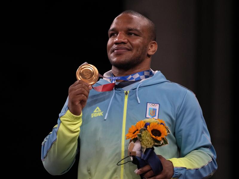 Gold medalist Zhan Beleniuk of Ukraine celebrates on the podium during the medal ceremony for men's 87-kilogram Greco-Roman wrestling. Gold medalist Zhan Beleniuk of Ukraine celebrates on the podium during the medal ceremony for men's 87-kilogram Greco-Roman wrestling.