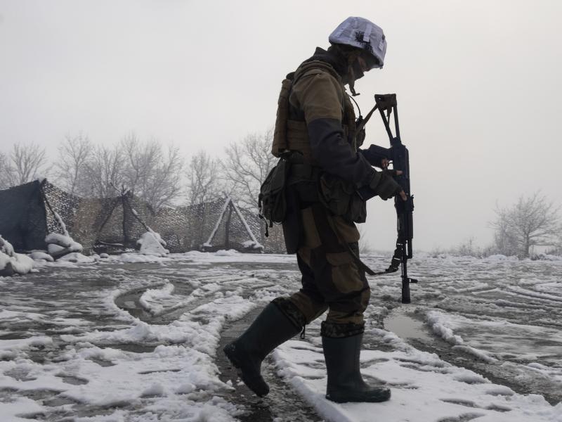 A Ukrainian soldier walks at the line of separation from pro-Russian rebels near Popasna, Donetsk region, Ukraine, on Tuesday. A Ukrainian soldier walks at the line of separation from pro-Russian rebels near Popasna, Donetsk region, Ukraine, on Tuesday.